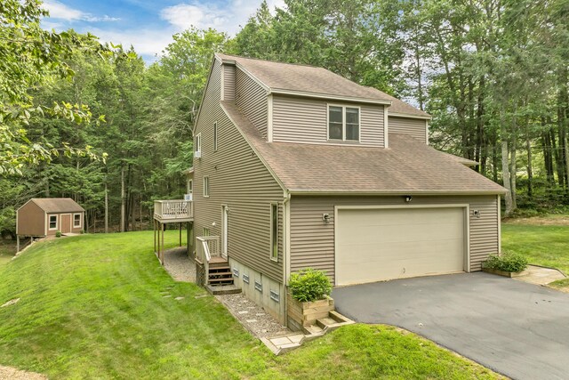 125 Deer Ridge Dr, Barrington, NH 03825 - view of front facade with a shingled roof, a front yard, a wooden deck, and asphalt driveway