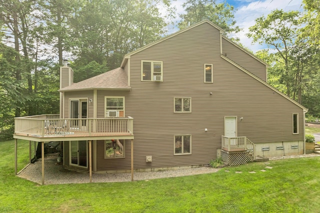 125 Deer Ridge Dr, Barrington, NH 03825 - rear view of house featuring a chimney, a wooden deck, a lawn, and roof with shingles
