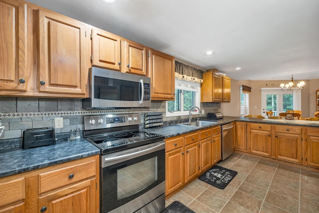 125 Deer Ridge Dr, Barrington, NH 03825 - kitchen featuring stainless steel appliances, a chandelier, dark countertops, decorative backsplash, and recessed lighting