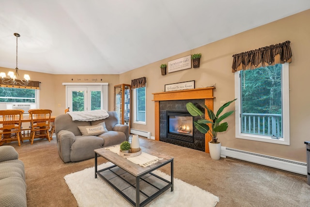 125 Deer Ridge Dr, Barrington, NH 03825 - carpeted living area featuring a baseboard heating unit, a chandelier, a tiled fireplace, cooling unit, and lofted ceiling