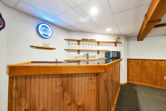 125 Deer Ridge Dr, Barrington, NH 03825 - indoor wet bar with black microwave, dark carpet, a drop ceiling, recessed lighting, and a wainscoted wall