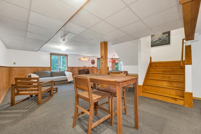 125 Deer Ridge Dr, Barrington, NH 03825 - carpeted dining space with a wainscoted wall, a drop ceiling, stairs, and wood walls