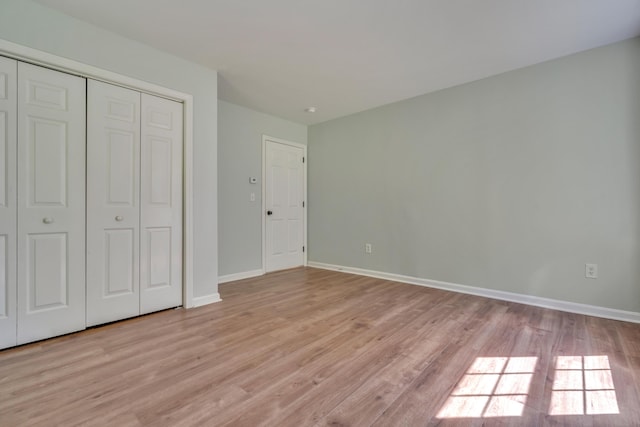 8 Woodside Dr Unit 1, Gorham, ME 04038 - unfurnished bedroom featuring light wood-style floors and a closet