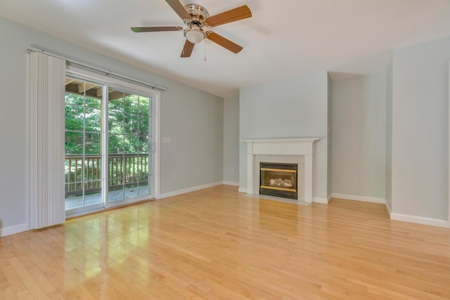 8 Woodside Dr Unit 1, Gorham, ME 04038 - unfurnished living room with light wood finished floors, a fireplace with flush hearth, and ceiling fan