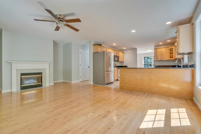 8 Woodside Dr Unit 1, Gorham, ME 04038 - kitchen with stainless steel appliances, dark countertops, light wood-style floors, a peninsula, and recessed lighting