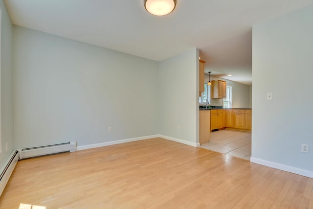 8 Woodside Dr Unit 1, Gorham, ME 04038 - unfurnished living room featuring light wood-type flooring and a baseboard radiator