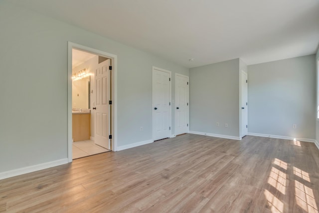 8 Woodside Dr Unit 1, Gorham, ME 04038 - unfurnished bedroom with light wood-style floors and ensuite bath