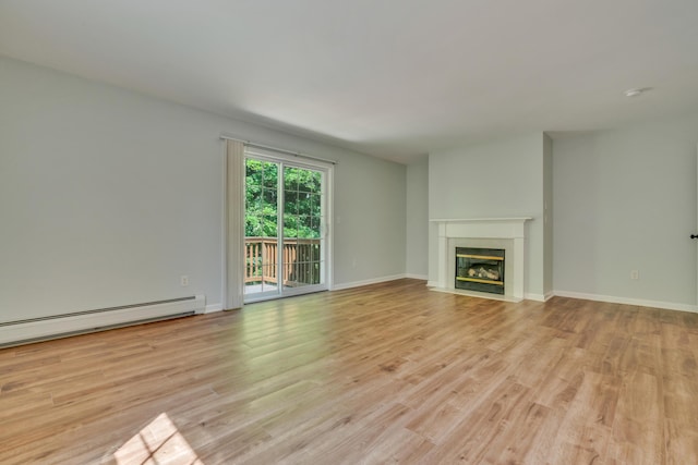 8 Woodside Dr Unit 1, Gorham, ME 04038 - unfurnished living room featuring light wood-type flooring, a fireplace with flush hearth, and a baseboard heating unit