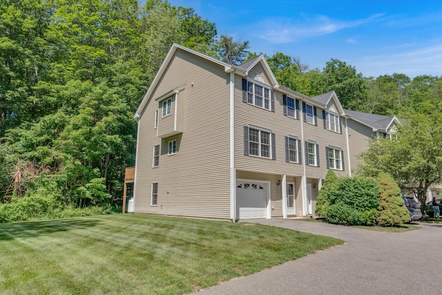 8 Woodside Dr Unit 1, Gorham, ME 04038 - view of front facade with a front lawn, an attached garage, and asphalt driveway