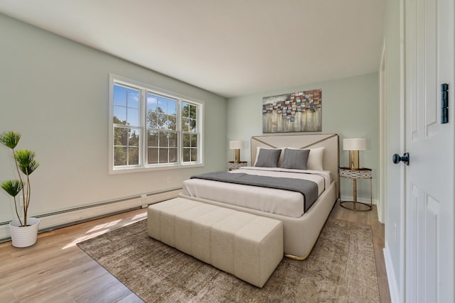8 Woodside Dr Unit 1, Gorham, ME 04038 - bedroom with wood finished floors and a baseboard heating unit