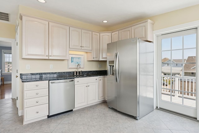 42 Rachel Carson Ln, Wells, ME 04090 - kitchen with stainless steel appliances, dark stone countertops, recessed lighting, and light tile patterned floors