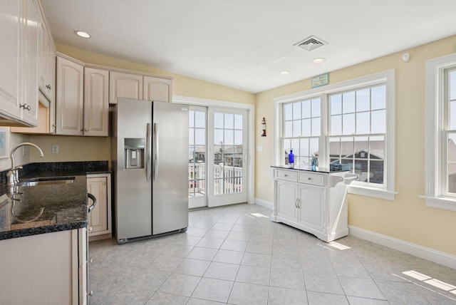 42 Rachel Carson Ln, Wells, ME 04090 - kitchen with stainless steel refrigerator with ice dispenser, dark stone countertops, light tile patterned floors, and recessed lighting