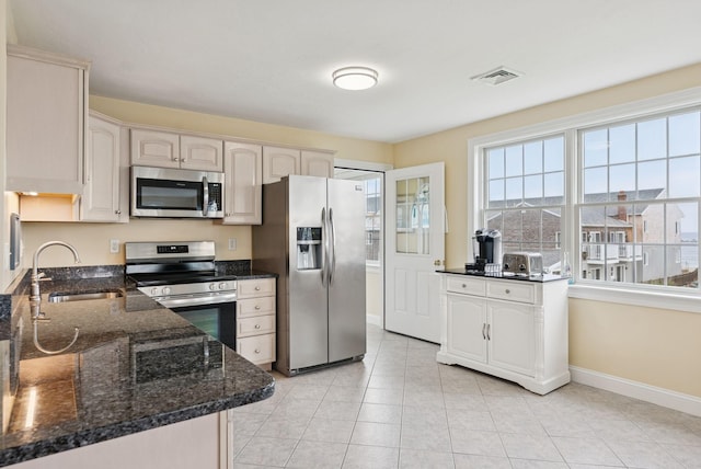42 Rachel Carson Ln, Wells, ME 04090 - kitchen with stainless steel appliances, light tile patterned floors, and dark stone countertops