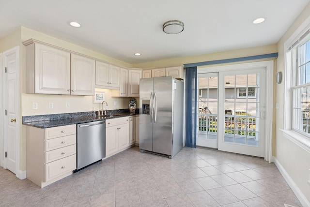 42 Rachel Carson Ln, Wells, ME 04090 - kitchen featuring stainless steel appliances, light tile patterned floors, dark stone counters, and recessed lighting