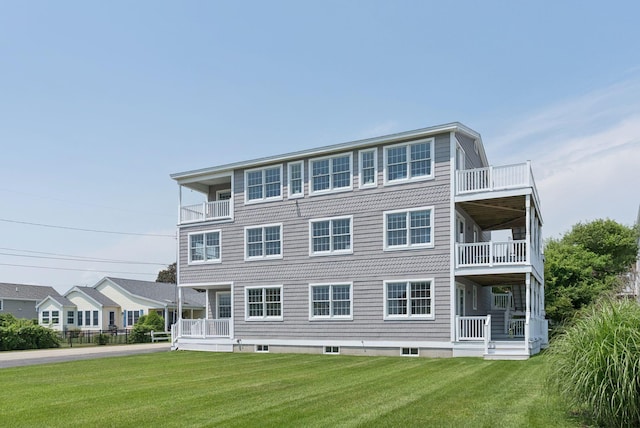 42 Rachel Carson Ln, Wells, ME 04090 - rear view of property with a balcony and a lawn
