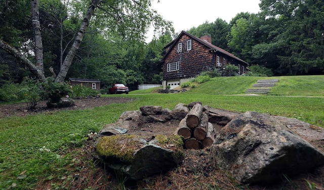 32 Williams Rd, Chelsea, ME 04330 - view of green lawn with a garage and a forest view