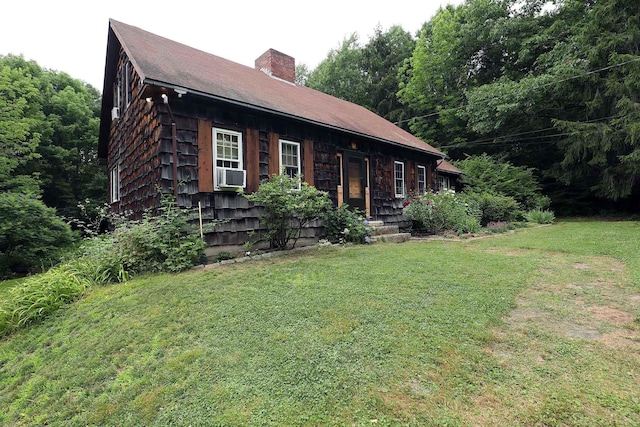 32 Williams Rd, Chelsea, ME 04330 - view of front of house with a front yard, a chimney, and cooling unit