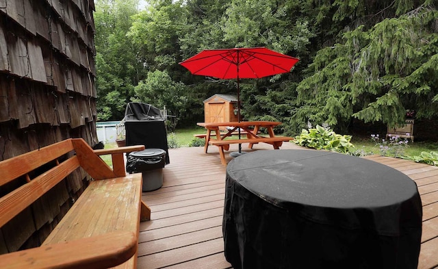 32 Williams Rd, Chelsea, ME 04330 - deck featuring a storage unit, a grill, and a forest view
