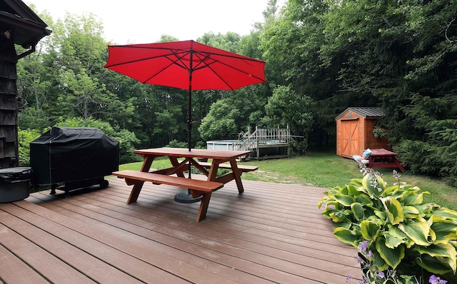 32 Williams Rd, Chelsea, ME 04330 - deck with grilling area, a storage unit, outdoor dining area, and a yard