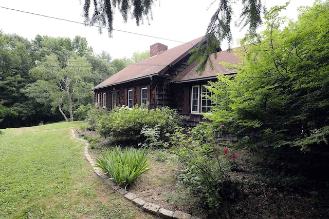 32 Williams Rd, Chelsea, ME 04330 - view of side of home featuring a chimney and a lawn