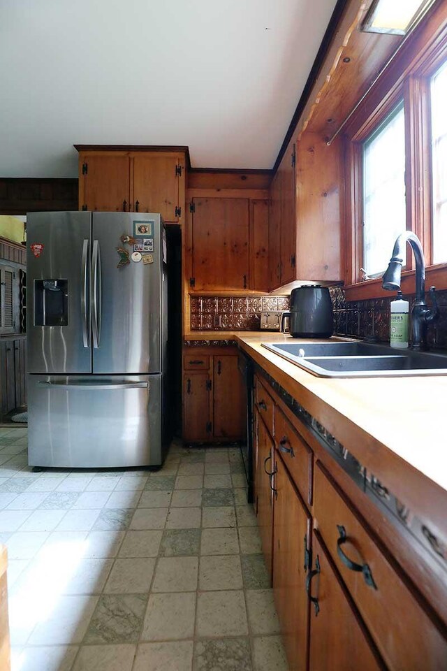 32 Williams Rd, Chelsea, ME 04330 - kitchen featuring stainless steel refrigerator with ice dispenser, brown cabinets, decorative backsplash, and light countertops