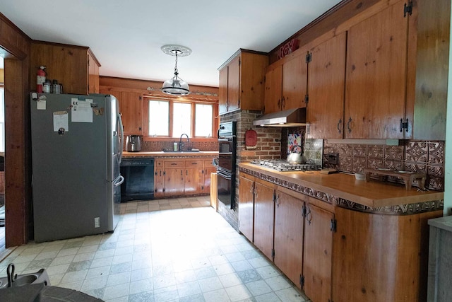 32 Williams Rd, Chelsea, ME 04330 - kitchen featuring black appliances, under cabinet range hood, light floors, backsplash, and brown cabinetry