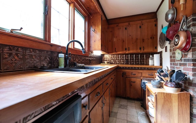 32 Williams Rd, Chelsea, ME 04330 - kitchen with tasteful backsplash, dishwashing machine, brown cabinetry, light stone finish flooring, and butcher block countertops