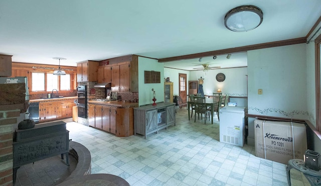 32 Williams Rd, Chelsea, ME 04330 - kitchen with light flooring, black appliances, under cabinet range hood, brown cabinetry, and ceiling fan