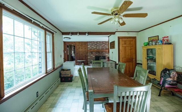 32 Williams Rd, Chelsea, ME 04330 - dining space featuring light flooring, a ceiling fan, baseboard heating, ornamental molding, and a brick fireplace