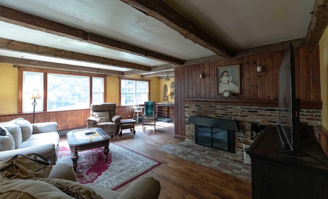 32 Williams Rd, Chelsea, ME 04330 - living room with wood walls, beam ceiling, wood finished floors, and a brick fireplace