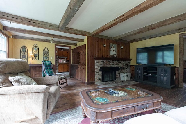 32 Williams Rd, Chelsea, ME 04330 - living area with hardwood / wood-style flooring, beamed ceiling, a fireplace, and wooden walls