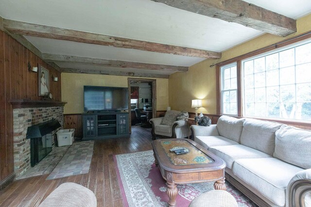 32 Williams Rd, Chelsea, ME 04330 - living area featuring beam ceiling, wood-type flooring, wooden walls, and a brick fireplace