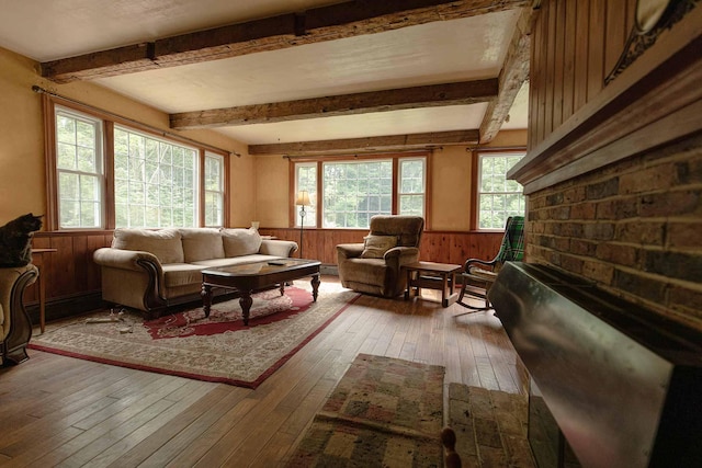 32 Williams Rd, Chelsea, ME 04330 - living area featuring hardwood / wood-style floors, beam ceiling, wainscoting, and wood walls