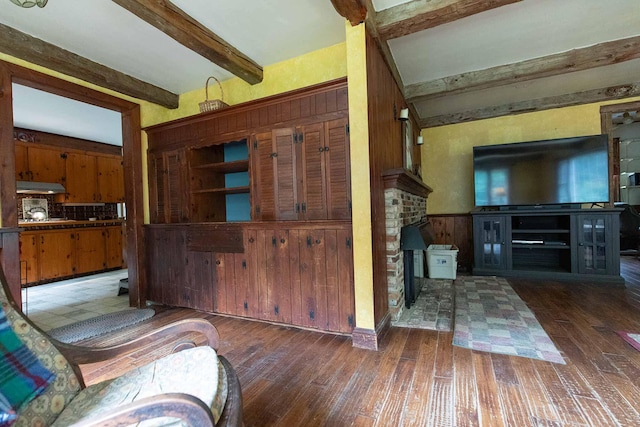 32 Williams Rd, Chelsea, ME 04330 - living area with beam ceiling, hardwood / wood-style floors, wood walls, and a wainscoted wall