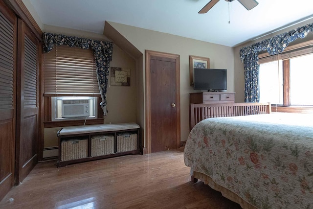 32 Williams Rd, Chelsea, ME 04330 - bedroom with cooling unit, wood finished floors, radiator heating unit, ceiling fan, and baseboard heating