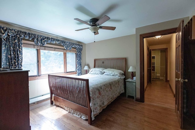 32 Williams Rd, Chelsea, ME 04330 - bedroom with a baseboard heating unit, wood finished floors, and a ceiling fan