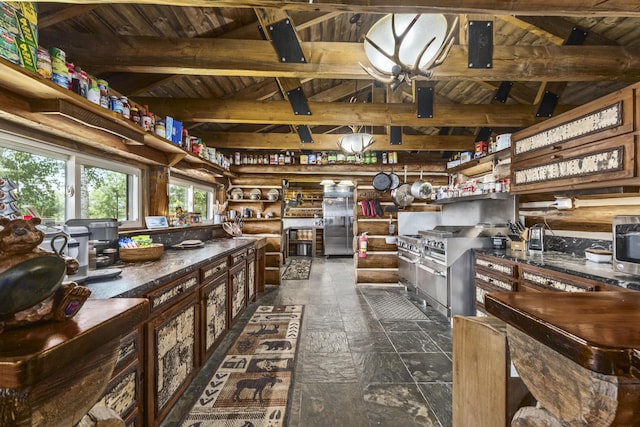 1 Zella Is Unit T14 R8, Wels, ME 04768 - kitchen featuring stone tile flooring, dark countertops, open shelves, and a wooden ceiling with exposed beams