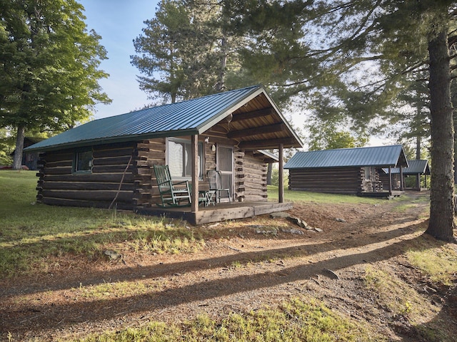 1 Zella Is Unit T14 R8, Wels, ME 04768 - view of property exterior with log exterior, a metal roof, and an outdoor structure