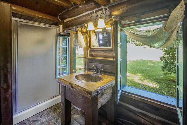 1 Zella Is Unit T14 R8, Wels, ME 04768 - full bathroom featuring a shower stall, healthy amount of natural light, vanity, a wooden ceiling with exposed beams, and stone finish flooring