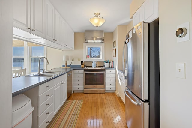 74 Spindle Rd, Ellsworth, ME 04605 - kitchen with appliances with stainless steel finishes, light wood-type flooring, white cabinetry, and dark countertops