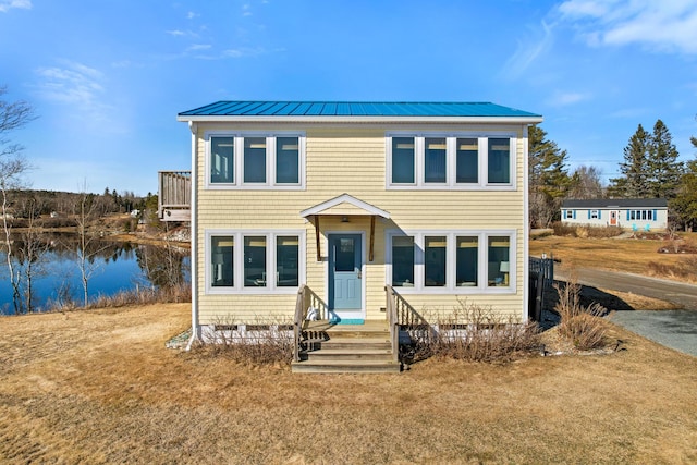 74 Spindle Rd, Ellsworth, ME 04605 - view of front of home featuring a water view, a front yard, and a metal roof