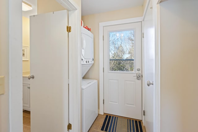 74 Spindle Rd, Ellsworth, ME 04605 - laundry room with stacked washer and clothes dryer and light tile patterned flooring