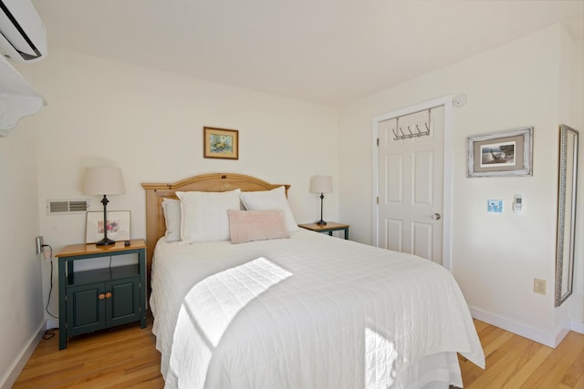 74 Spindle Rd, Ellsworth, ME 04605 - bedroom with a wall mounted AC and light wood-style flooring