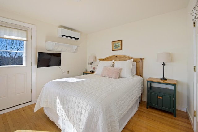 74 Spindle Rd, Ellsworth, ME 04605 - bedroom with an AC wall unit and light wood-style floors