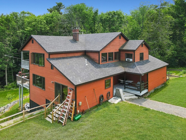 93 Hopkins Rd, Hampden, ME 04444 - view of front of home with a shingled roof, a balcony, a chimney, a front lawn, and a deck