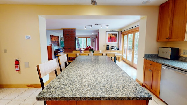 93 Hopkins Rd, Hampden, ME 04444 - kitchen with dishwasher, a center island, brown cabinets, and dark stone countertops