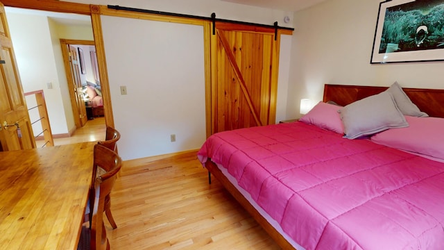 93 Hopkins Rd, Hampden, ME 04444 - bedroom featuring wood finished floors and a barn door
