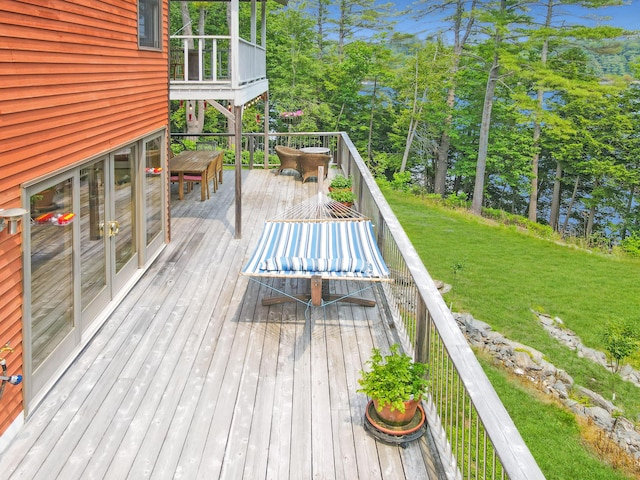 93 Hopkins Rd, Hampden, ME 04444 - wooden deck with outdoor dining space, a yard, and view of scattered trees
