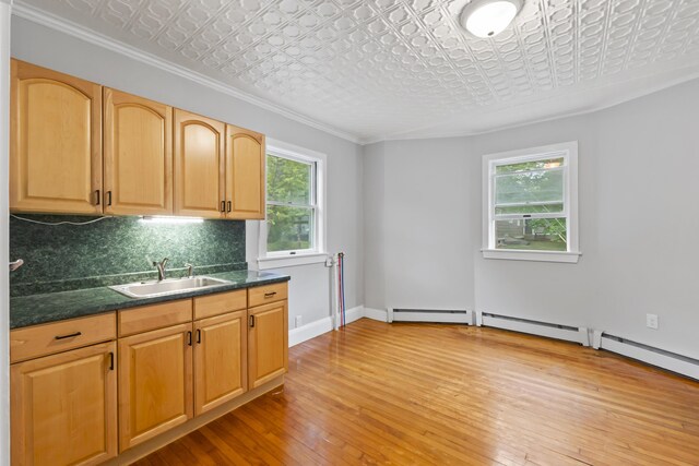 13 Newman St, Lewiston, ME 04240 - kitchen with an ornate ceiling, healthy amount of natural light, tasteful backsplash, light wood-style floors, and crown molding