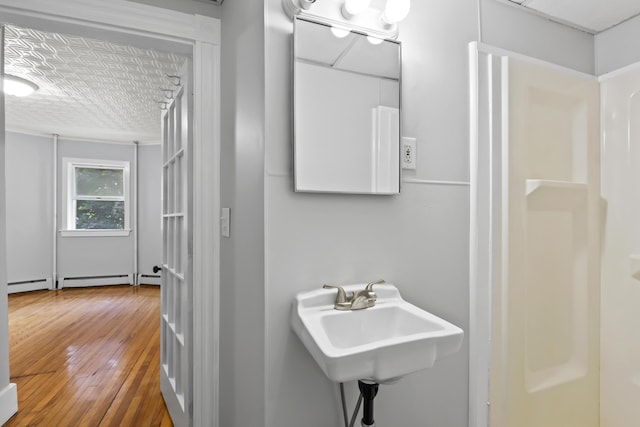 13 Newman St, Lewiston, ME 04240 - full bath featuring hardwood / wood-style floors, a baseboard radiator, baseboard heating, and a shower